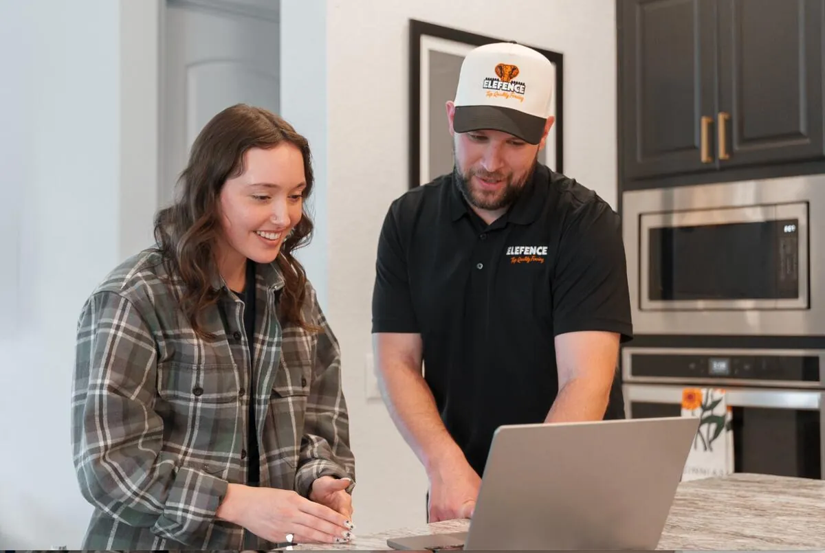EleFence fence installers reviewing custom fence installation estimate with Austin TX homeowner for residential fence installation